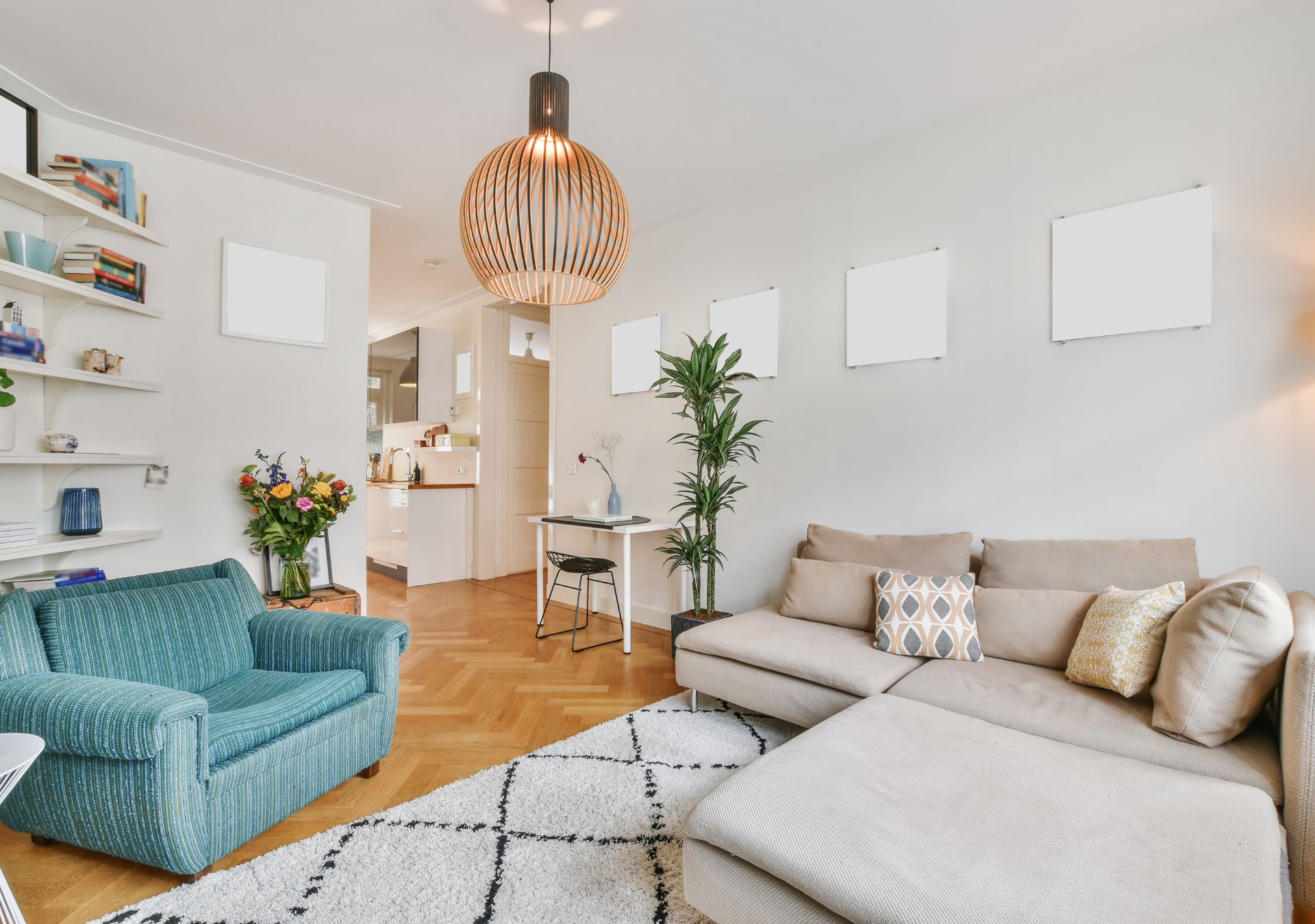 Living room with blue armchair, beige sectional and pendant light