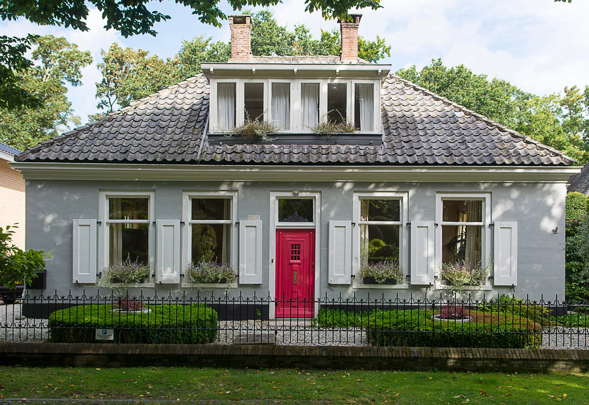 White cottage with red front door