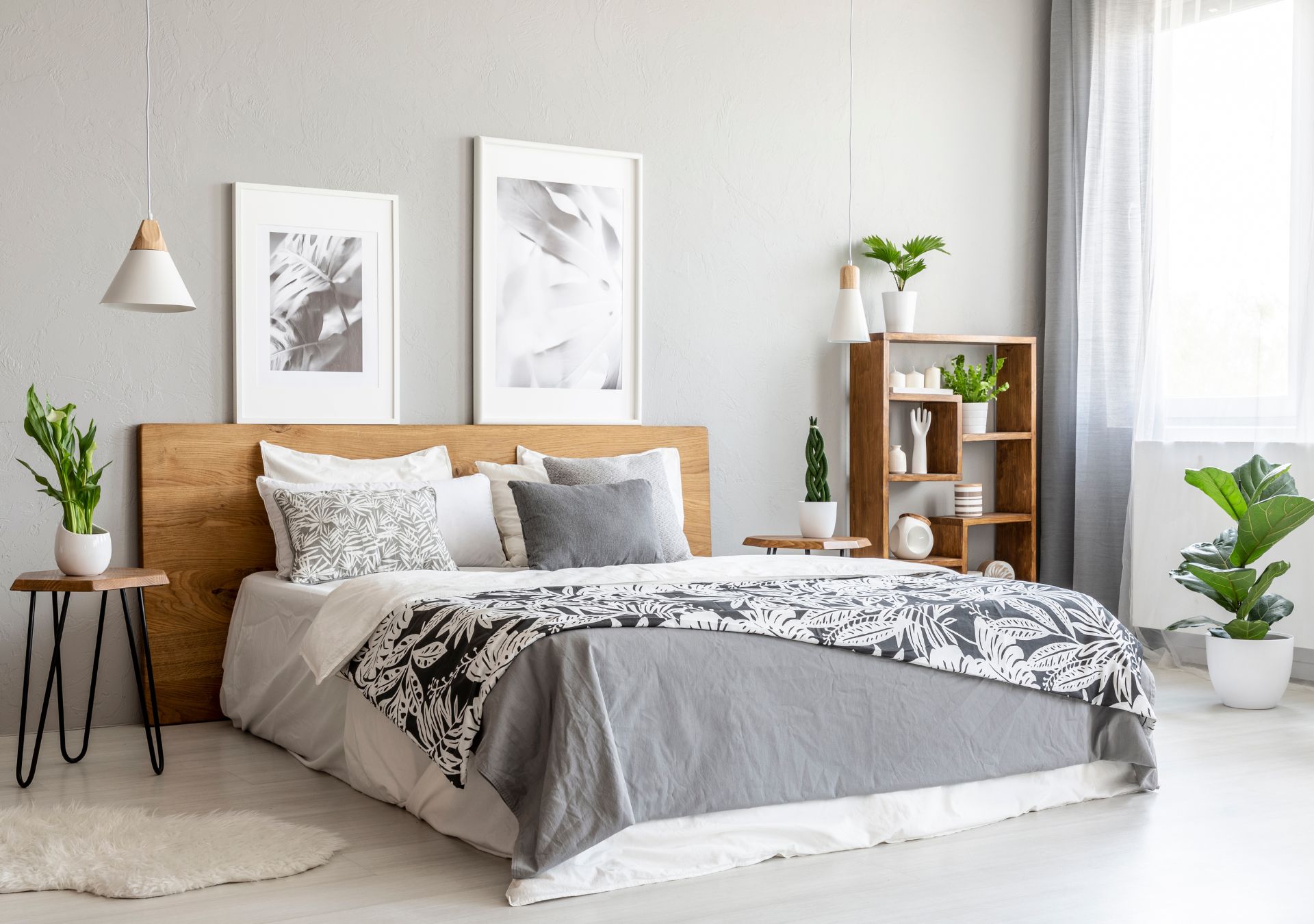 Bedroom with wood bed frame and gray bedding