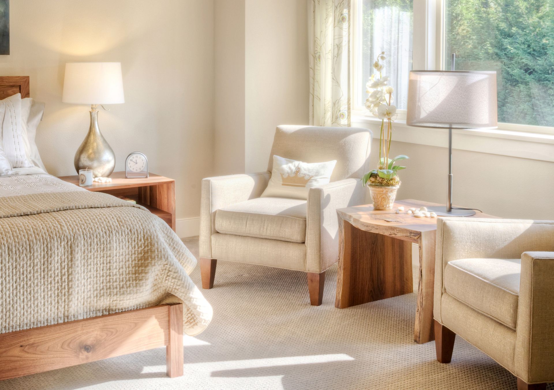Sitting room with two beige armchairs and garden view