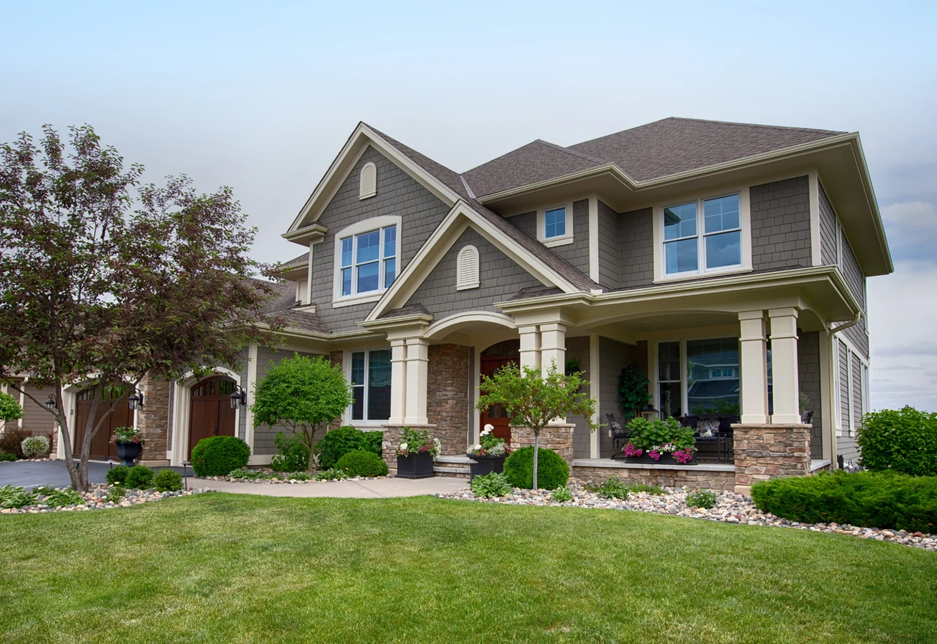 Gray shingle-style home exterior at twilight