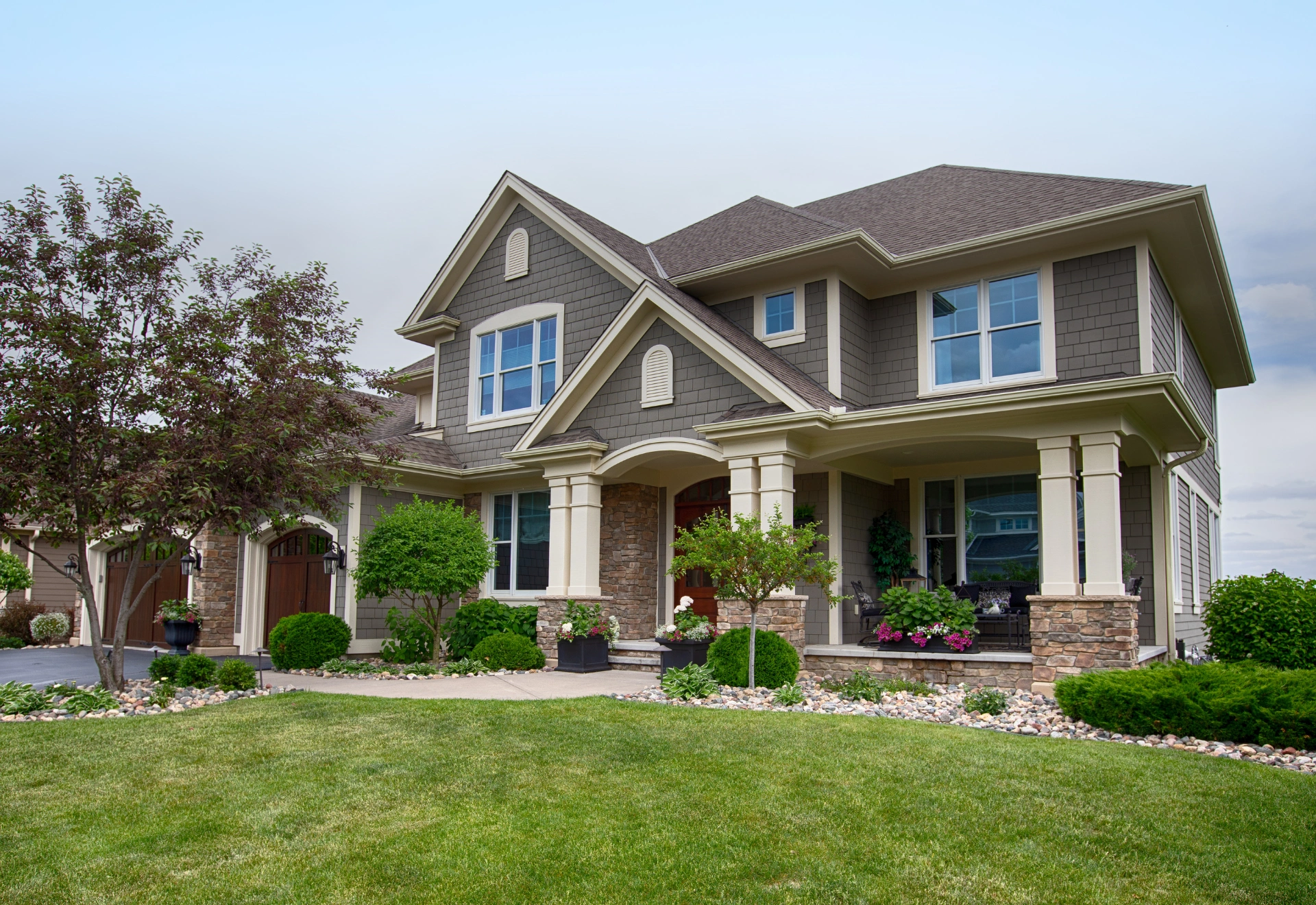 Gray shingle-style home exterior at twilight