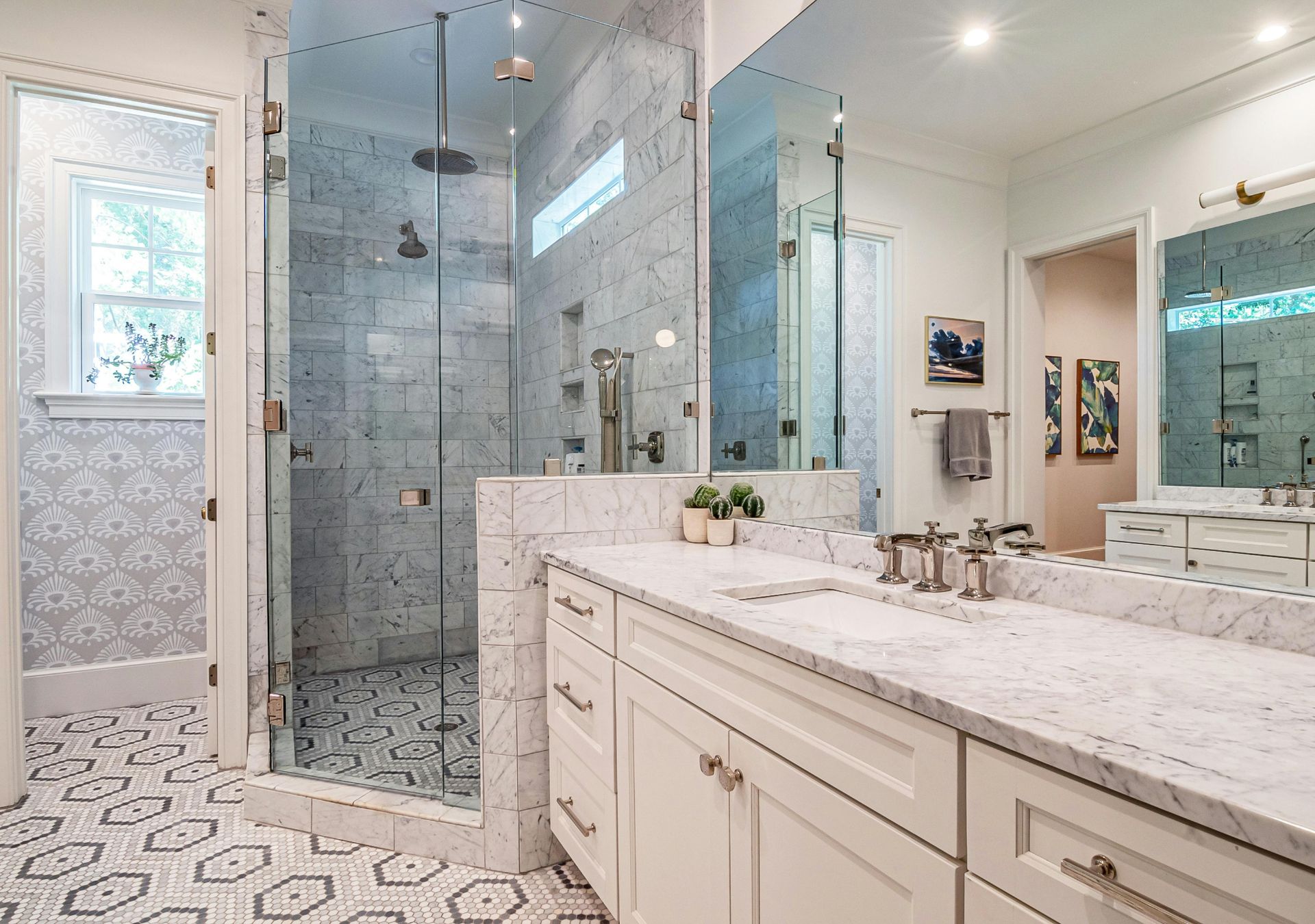 Luxury bathroom with glass-enclosed shower and marble double vanity