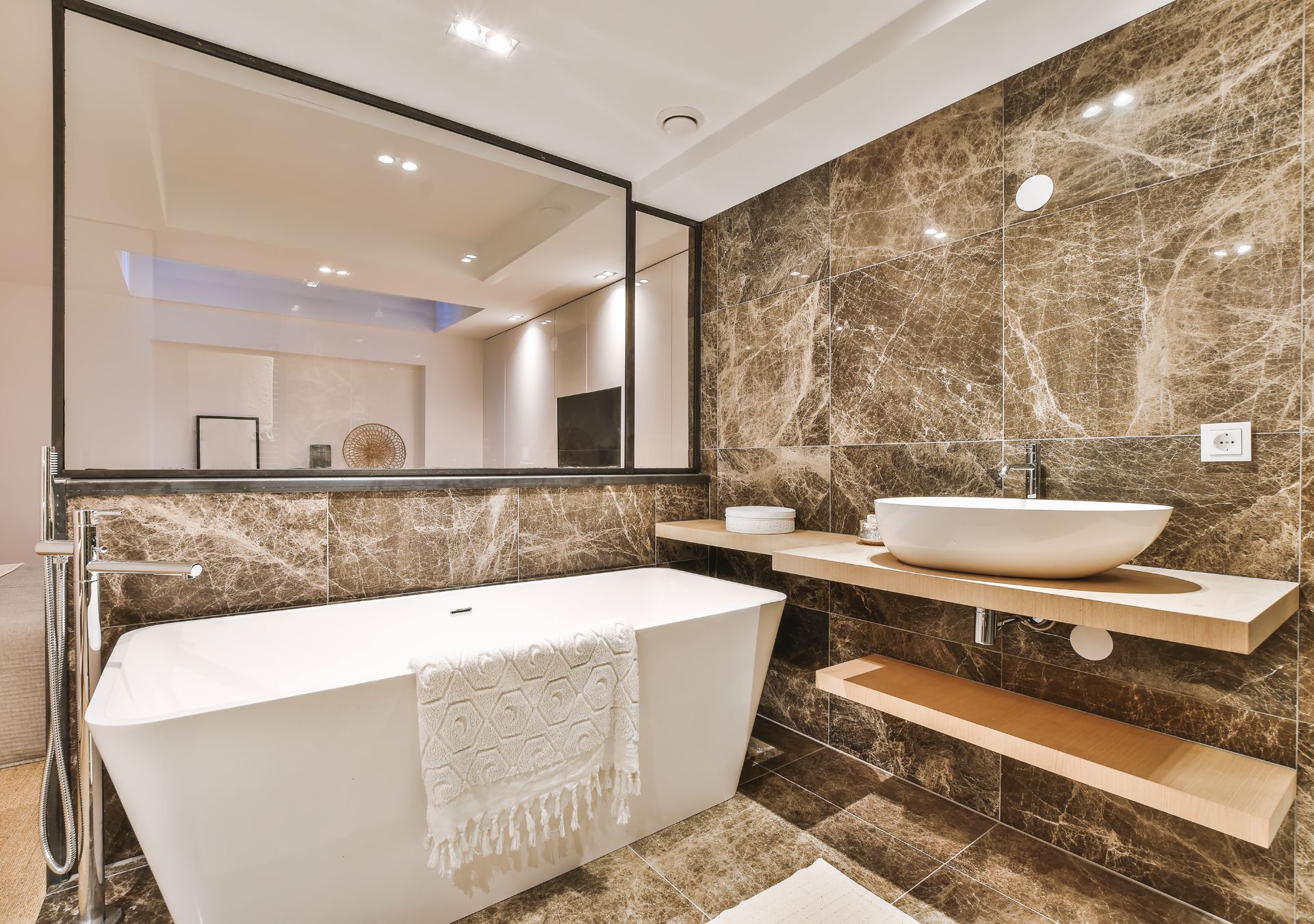 Luxury bathroom with marble walls and freestanding tub
