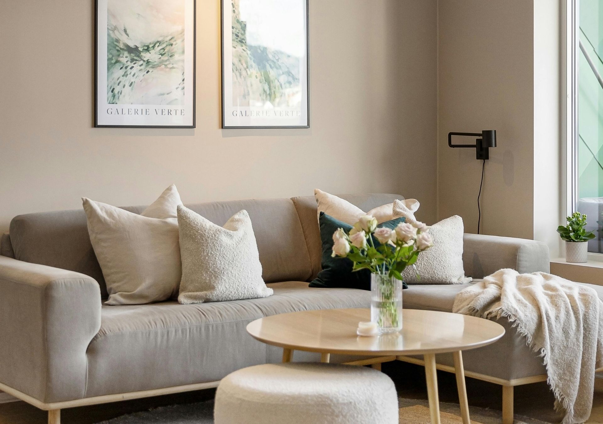 Living room with gray sofa, round coffee table and floral arrangement