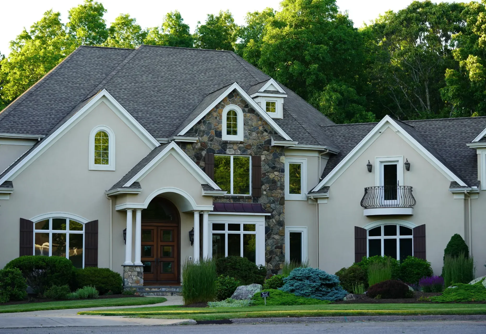 Beige home with stone arched entryway