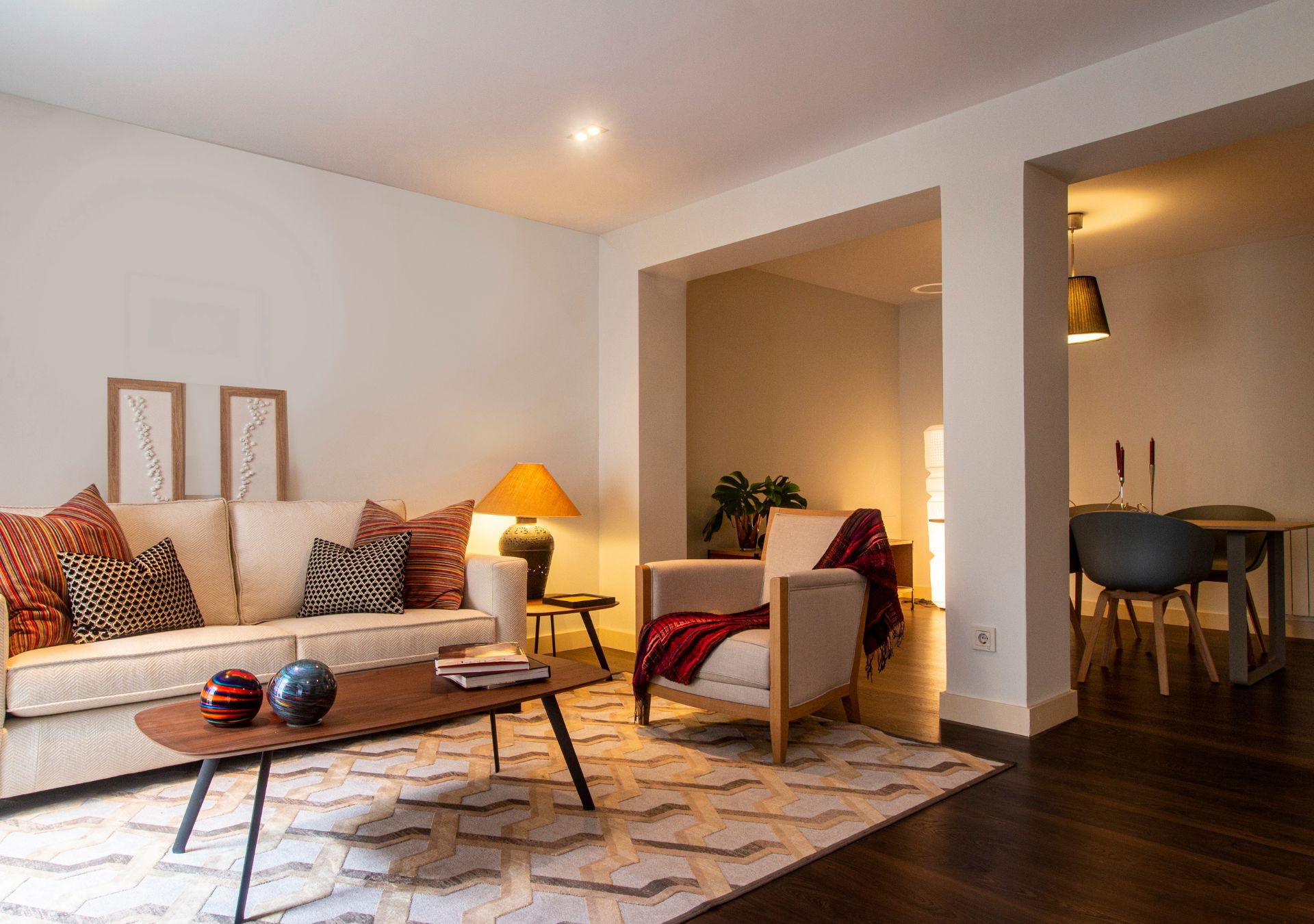 Warm living room with beige sofas and large windows