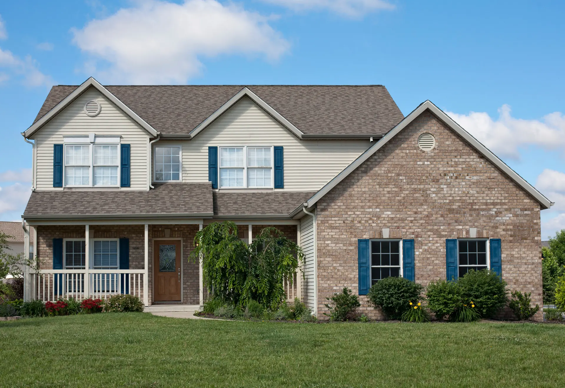 Two-story brick house with blue shutters